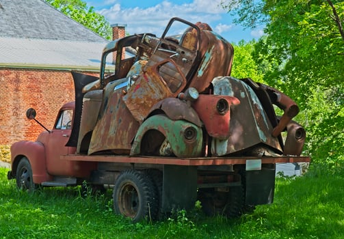 Vintage truck with old car parts photo