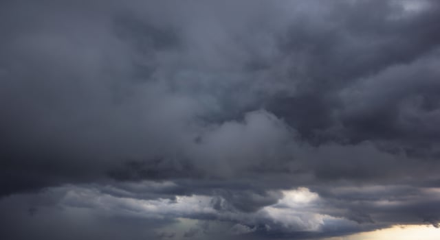 The dark sky with heavy clouds converging and a violent storm before the rain.Bad or moody weather sky and environment. carbon dioxide emissions, greenhouse effect, global warming, climate change photo