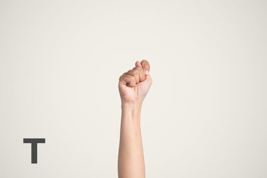 Deaf Sign alphabet of T, American Sign Language ASL. Isolated object Finger spelling the alphabet photo