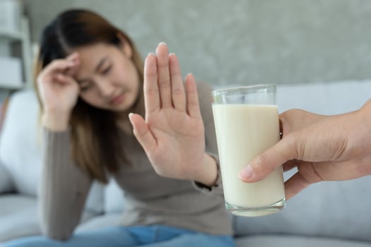 Milk allergens, Sick sad unhealthy ill allergic woman, runny stuffy sore nose suffer from intolerance allergy trigger symptoms. abdominal pain, allergens, nut protein, rash, death, food allergy photo