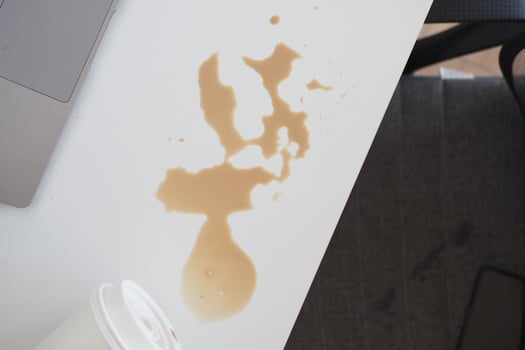 A white table with a laptop and a cup of coffee photo