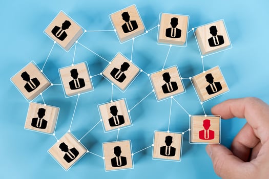 Hand touch red human icon on wooden block from team with line connection symbol for spread influence photo