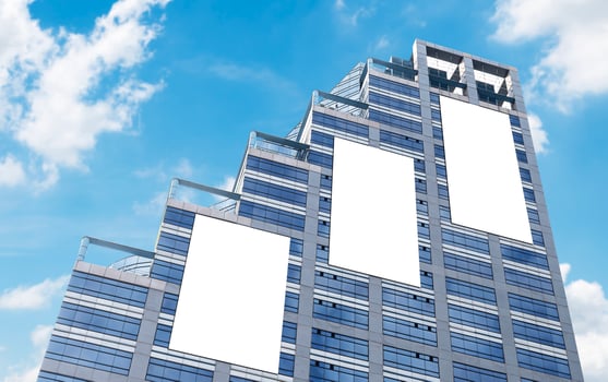 Mock up three white vertical large LED display billboard on tower building with blue sky background .clipping path for mockup photo