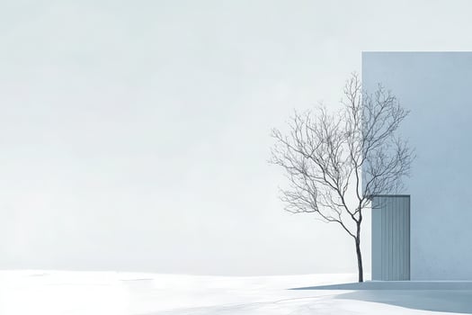 Amidst a serene winter atmosphere, a lone bare tree stands next to a clean white structure, reflecting a minimalist aesthetic. The bright sky adds tranquility to the scene. photo