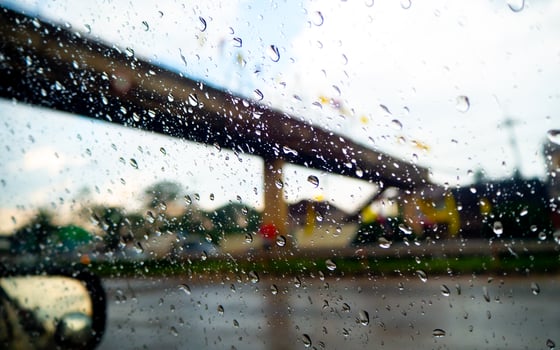 Rain and dew drop on the car glass window during raining. photo