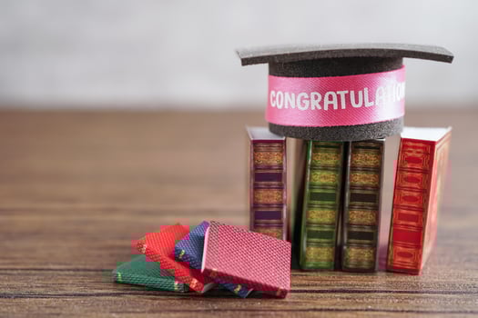 Graduation hat on book with copy space, learning university education. photo