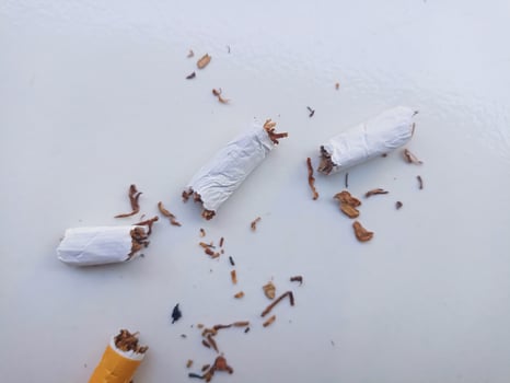 Stop smoking, quit smoking or no smoking cigarettes. Woman holding broken cigarette in hands. Woman refusing cigarettes and lung health concept. photo