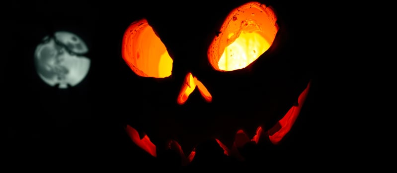 glowing carved pumpkin with intriguing eyes photo