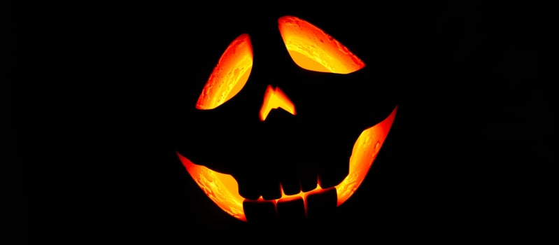 glowing carved pumpkin grin photo