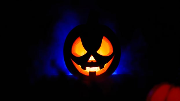 glowing carved pumpkin with a menacing grin photo
