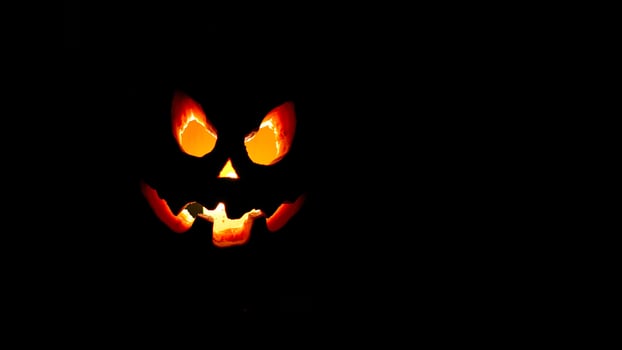 glowing jack-o'-lantern with a menacing grin photo
