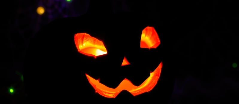 glowing jack-o-lantern smiles against a dark background photo