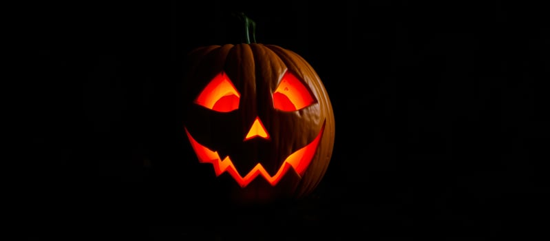 glowing carved pumpkin with a toothy grin photo