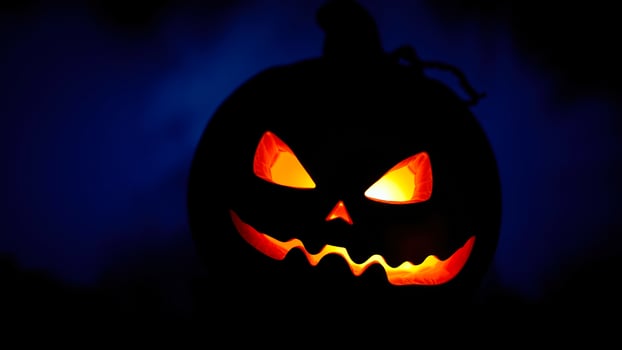 glowing carved pumpkin with a menacing grin photo