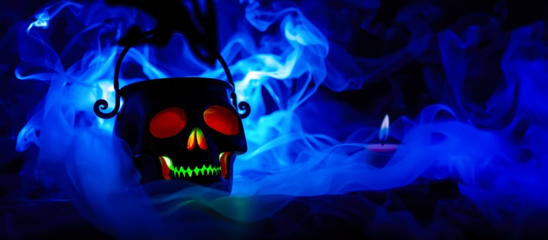 glowing skull-shaped container blue smoke photo