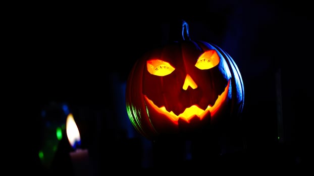 carved pumpkin glows with a sinister smile photo