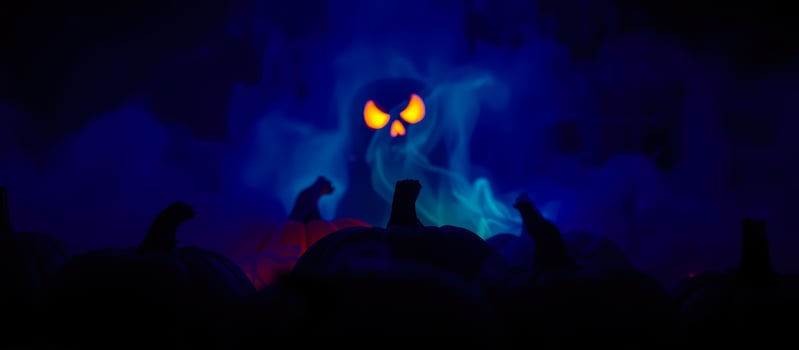 ghostly figure looms over pumpkins a smoky halloween scene photo