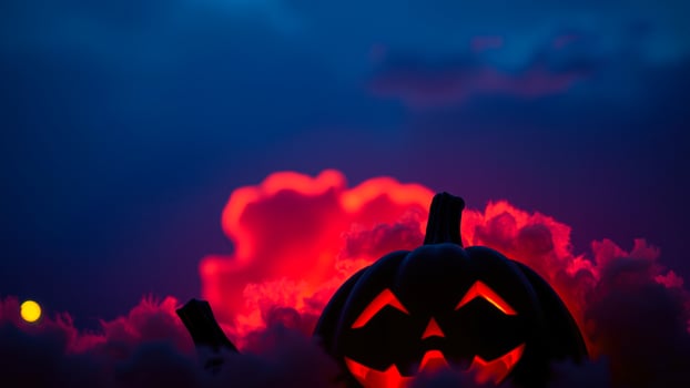 glowing jack-o'-lantern against a dramatic sky photo