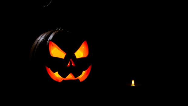 glowing jack-o-lantern candle the dark photo