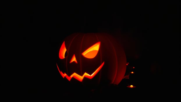glowing carved pumpkin with a sinister smile photo