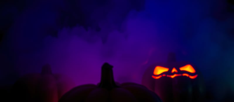 glowing pumpkins foggy night photo