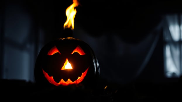 glowing jack-o'-lantern a darkened room photo