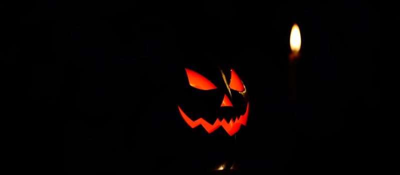 carved pumpkin with a lit candle creates a spooky atmosphere photo