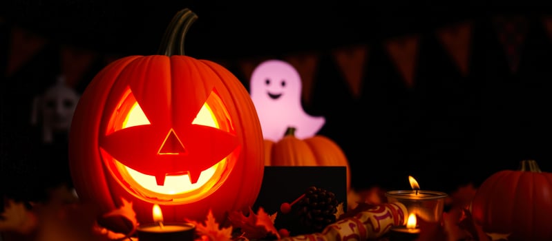 smiling jack-o'-lantern illuminates a festive halloween table photo