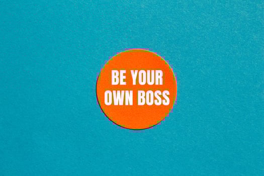 Be your own boss message written on round orange sticker with blue background. Conceptual be your own boss symbol. Copy space. photo