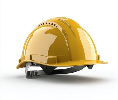 A yellow hard hat resting on a flat surface in a well lit indoor setting photo