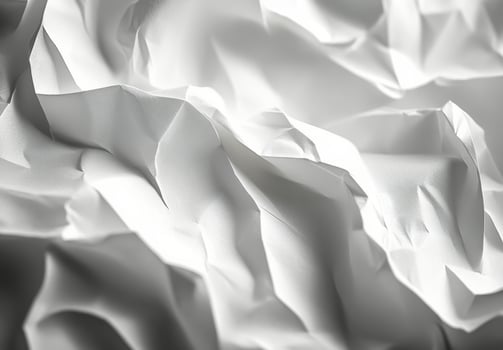 Textured white paper layers creating a delicate and intricate pattern in soft lighting photo