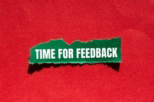 Time for feedback message written on ripped torn green paper piece with red background. Conceptual time for feedback symbol. Copy space. photo