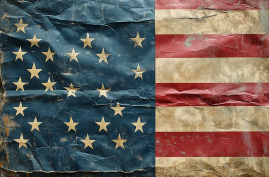 American flag draped subtly against a textured gray background in a minimalistic setting photo