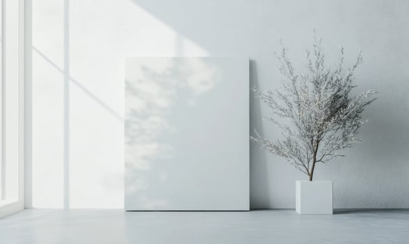 A white framed picture sits on a white wall photo