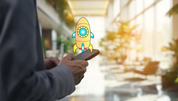 Businessman holding smartphone with rocket icon on screen photo