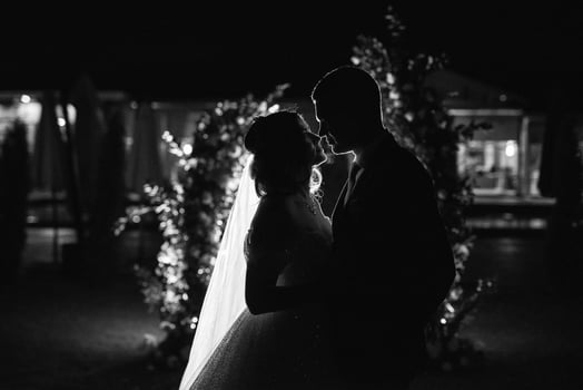 girl and guy against the background of a night wedding arch photo