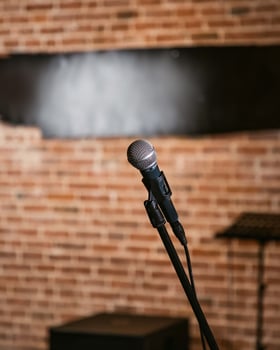 Microphone standing on stage with brick wall background photo