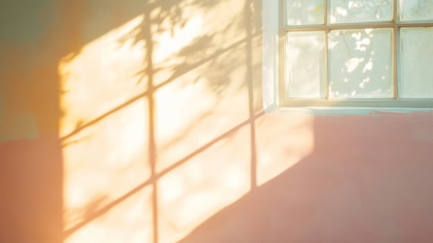 Sunlight Streaming Through a Window Casting Shadow Patterns on a Wall photo