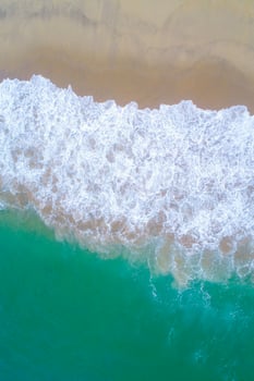 shore of a turquoise water beach as seen from a drone, zenithal view. Summer holidays background photo