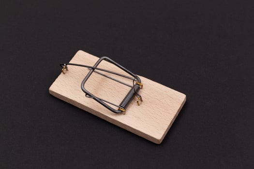 Wooden Mouse Trap. Empty Loaded Mousetrap on Black Background photo