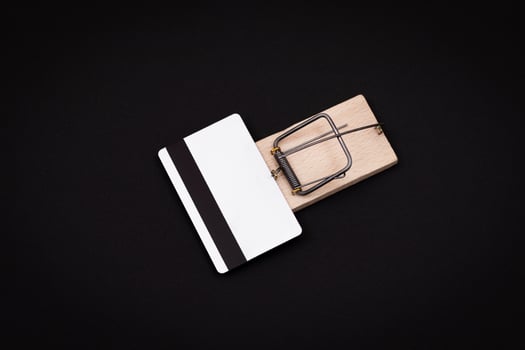 Credit Risk and Loan Trap - White Blank Credit Card Template in Wooden Mouse Trap on Black Background photo