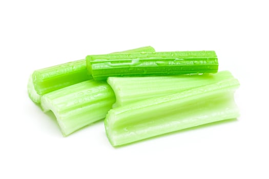Fresh Chopped Celery Sticks with Water Drops Isolated on White Background. Vegan and Vegetarian Culture. Raw Food. Healthy Diet with Negative Calorie Content photo