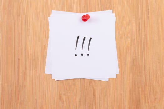 White Sticky Notes with Three Exclamation Points Pinned to the Wooden Message Board. To Do List Reminder in the Office. Memo Note at Work photo