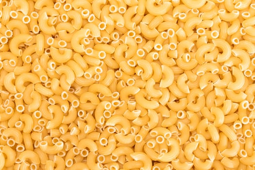Uncooked Chifferi Rigati Pasta Background. Fat and Unhealthy Food. Classic Dry Macaroni Texture. Italian Culture and Cuisine. Raw Pasta photo