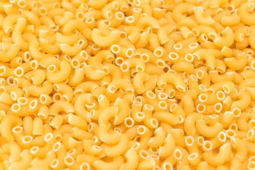 Uncooked Chifferi Rigati Pasta Background. Fat and Unhealthy Food. Classic Dry Macaroni Texture. Italian Culture and Cuisine. Raw Pasta photo