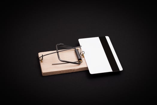 Credit Risk and Loan Trap - White Blank Credit Card Template in Wooden Mouse Trap on Black Background photo