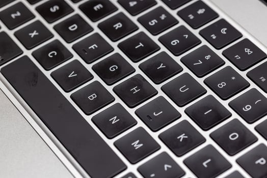 keyboard of famous silver colored laptop with fingerprints photo