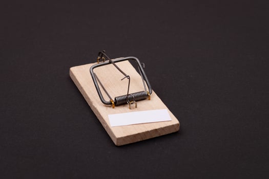 Blank White Sheet of Paper in Wooden Mousetrap - Template. Small Memo Paper in Mouse Trap on Black Background photo