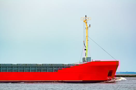 Orange cargo ship. Logistics and merchandise transportations photo