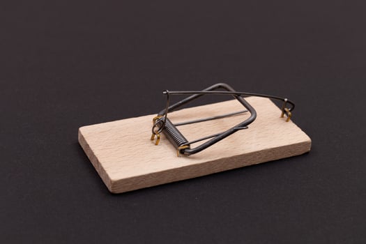 Wooden Mouse Trap. Empty Loaded Mousetrap on Black Background photo
